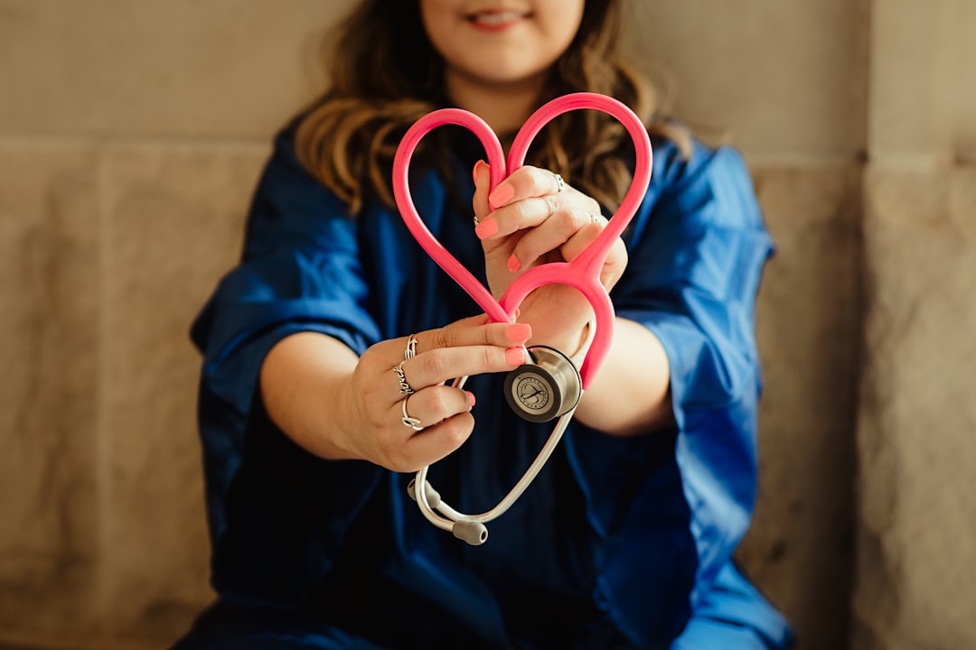 services-10 woman-in-scrubs-holding-heart-shaped-stethoscope-y-3dt0us7e0